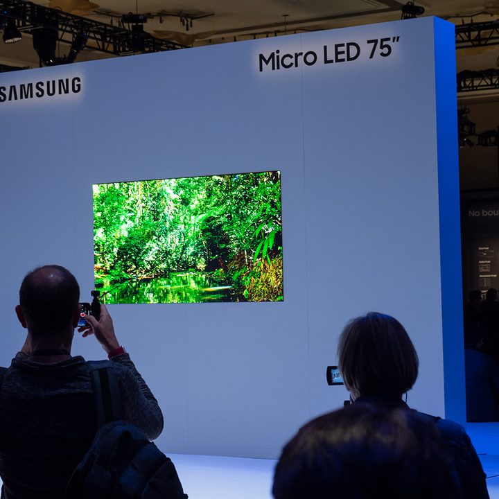 Viewers examine a Samsung Micro LED 75-inch TV on display.