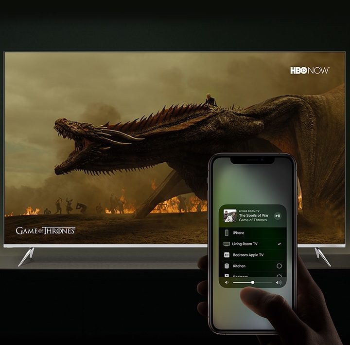 Using AirPlay 2 on an iPhone in front of a TV.