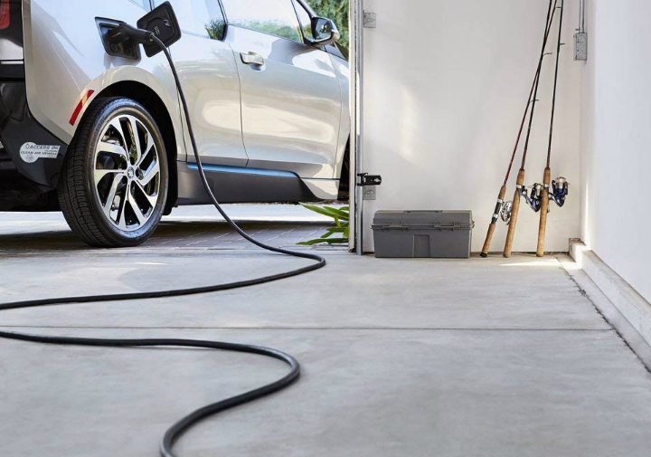 An electric vehicle plugged into a garage outlet.