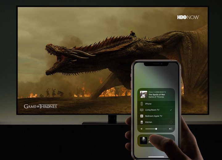 iPhone with AirPlay on its screen with Game of Thrones on the TV in the background.