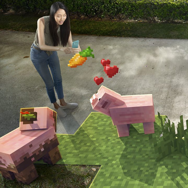 A girl feeds her AR pigs AR carrots | Minecraft Earth Key Art
