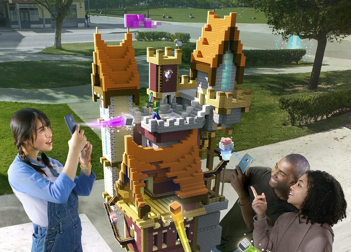 Players building a castle structure together in a park| Minecraft Earth Key Art