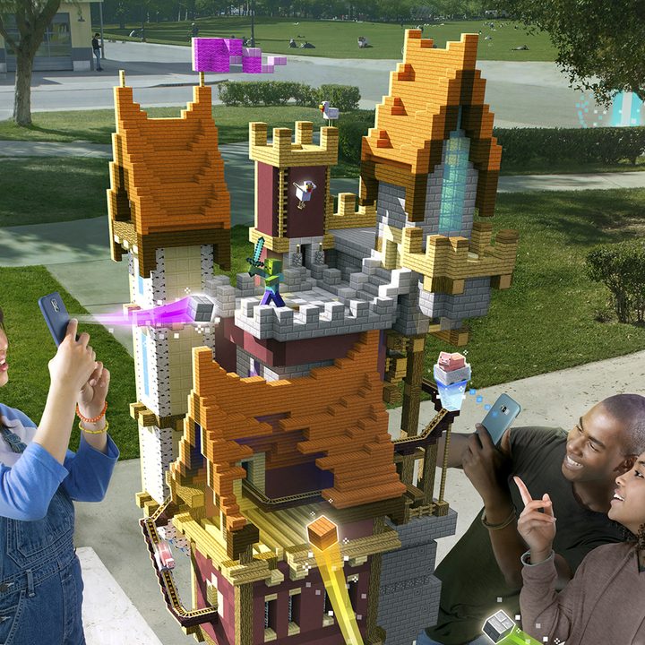 Players building a castle structure together in a park| Minecraft Earth Key Art