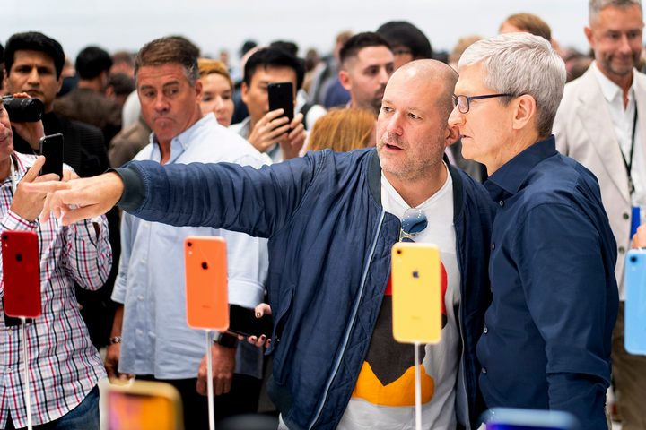 Jony Ive (left) and Apple CEO Tim Cook look over iPhones during a launch event leading up to the release of the iPhone X, XR, and XS.