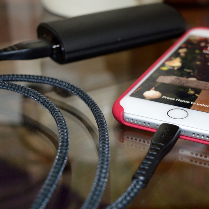 Close-up a lightning cable while an iPhone charges.