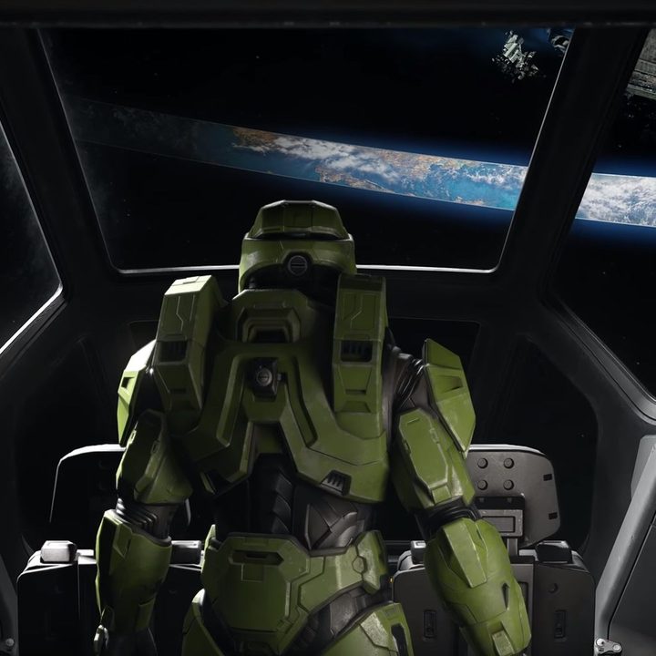 Master chief looking at a halo from a ship's cockpit.