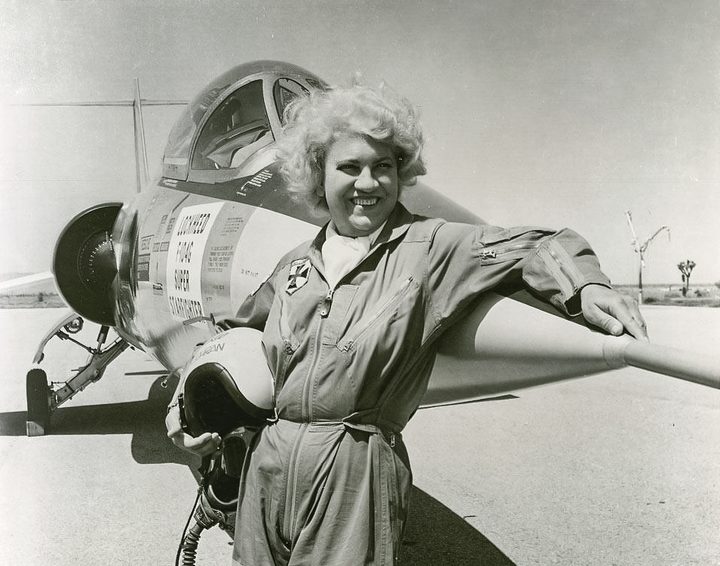 Jacqueline Cochran standing outside of a P-40 Warhawk Fighter Plane