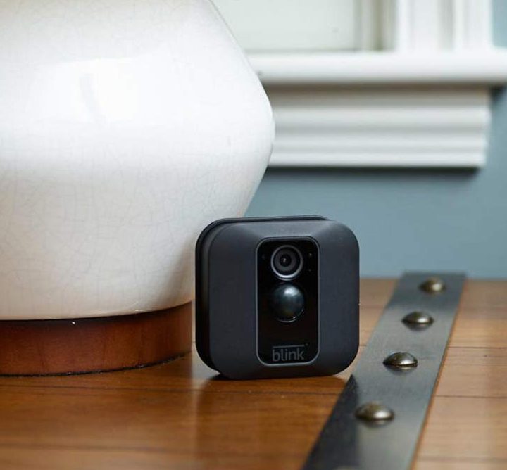 A Blink XT2 Smart Security Camera on an end table.