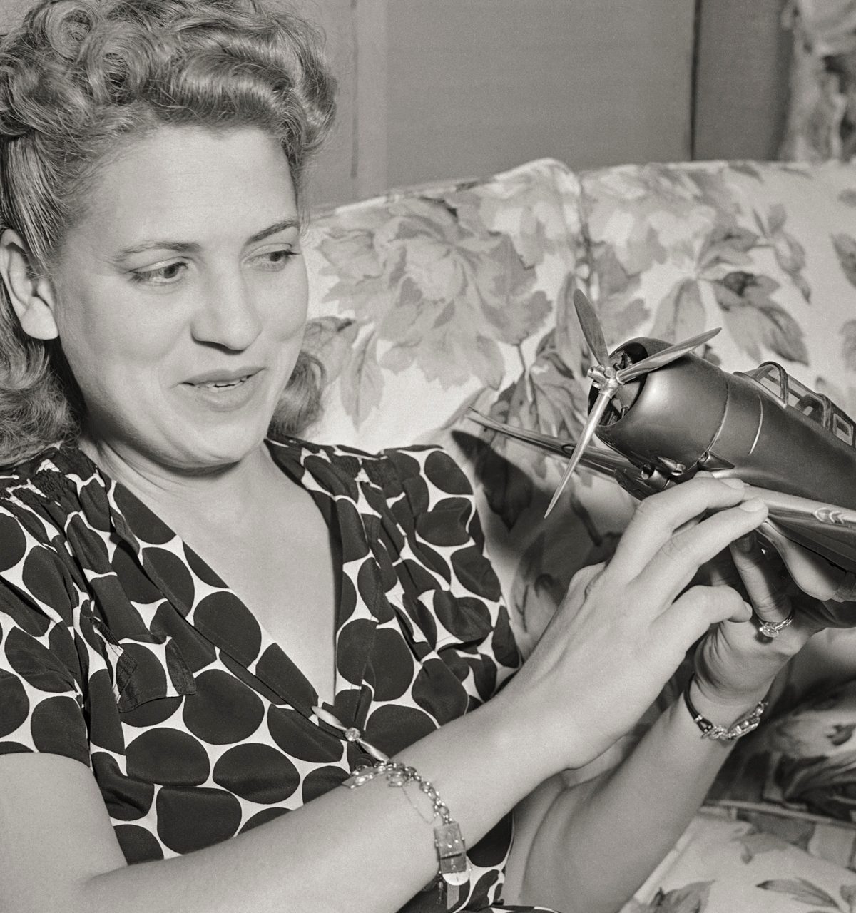 Jacqueline Jackie Cochran looking at a model airplane