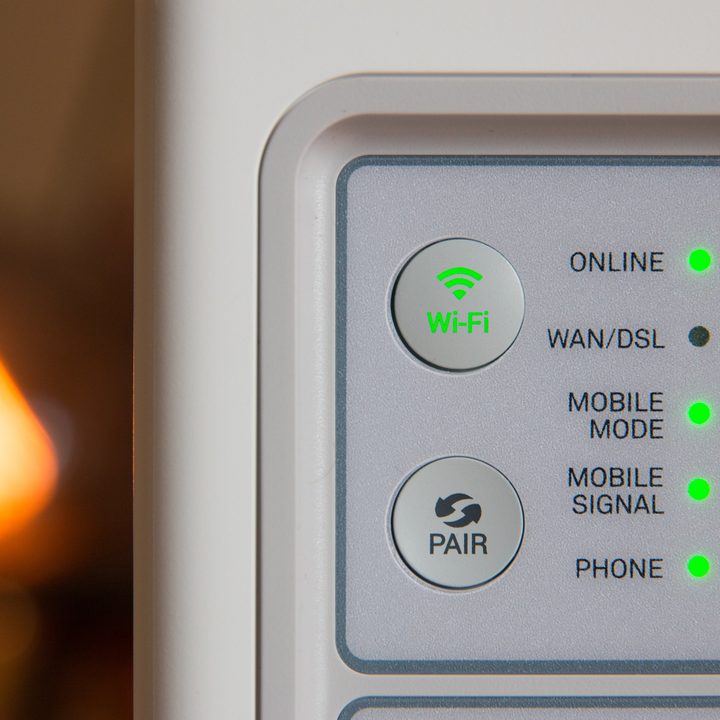 A modem with all lights lit up green.