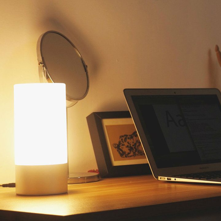 The Aukey Table Lamp beside a laptop.