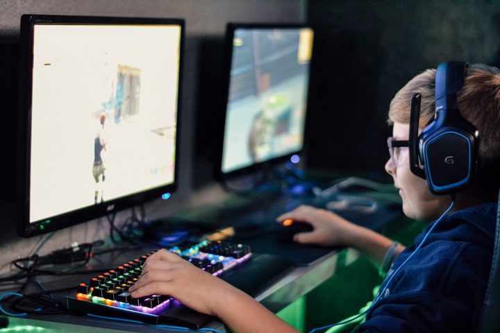 Gamer gaming using mouse and RGB keyboard