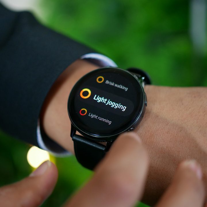Samsung Galaxy Watch Active 2 on a wrist displaying an activities menu.