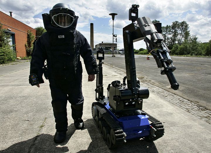 A bomb disposal expert and robot