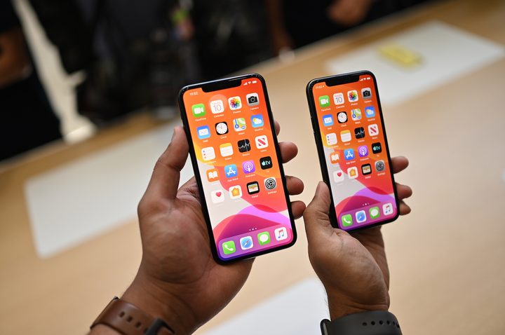 The iPhone 11 Pro Max and Pro side-by-side in-hand