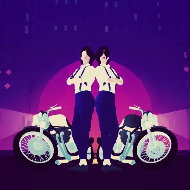 Two women standing back to back next to motorcycles.