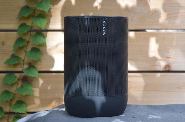 The Sonos Move placed outside next to a fence.