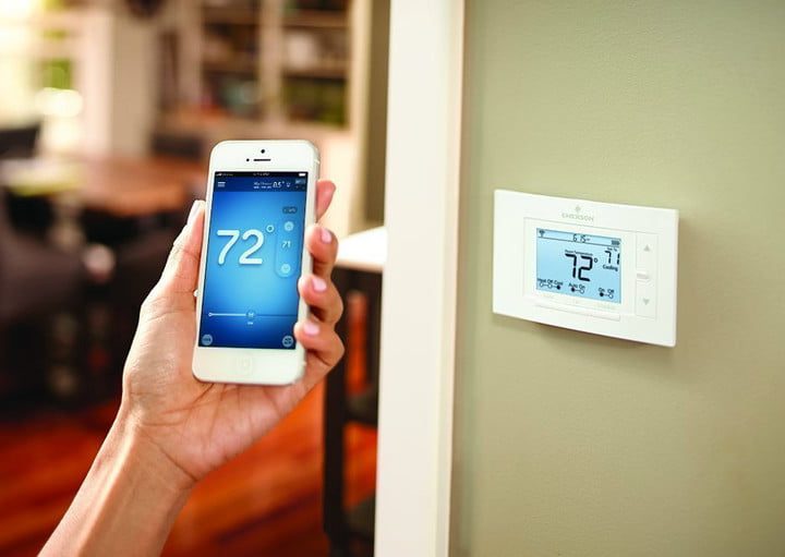 Comparing temps between a smartphone app and a smart thermostat on the wall.