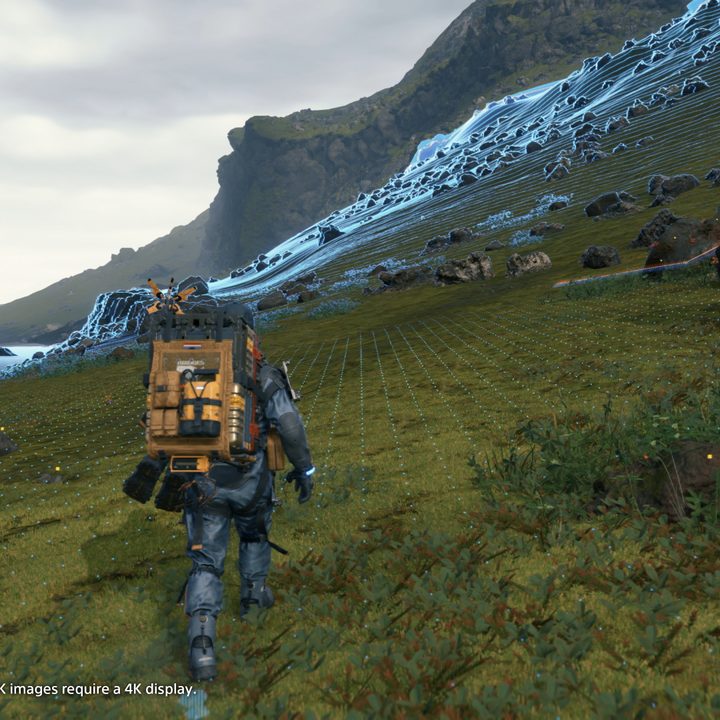 Sam Bridges walks across a valley in Death Stranding.