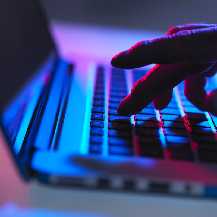 A person types on a computer keyboard.