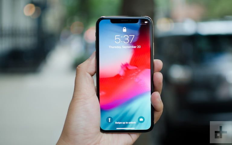 A hand holding an iPhone.