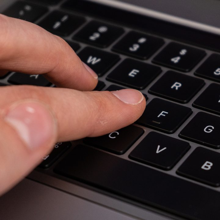 A closeup of someone typing on the M1 MacBook Pro