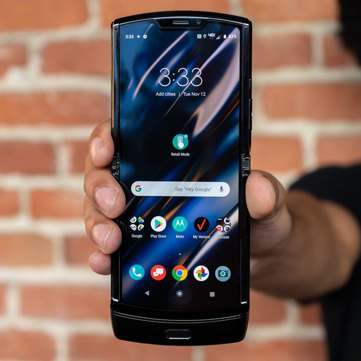 The Motorola Razr being held up near a wall.