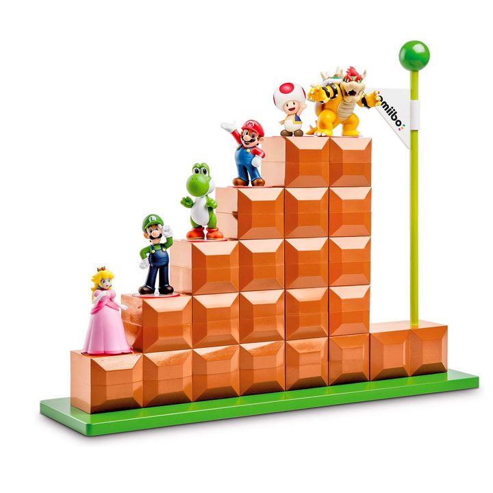 Amiibo sit on top of a PowerA stand shaped like Mario blocks.