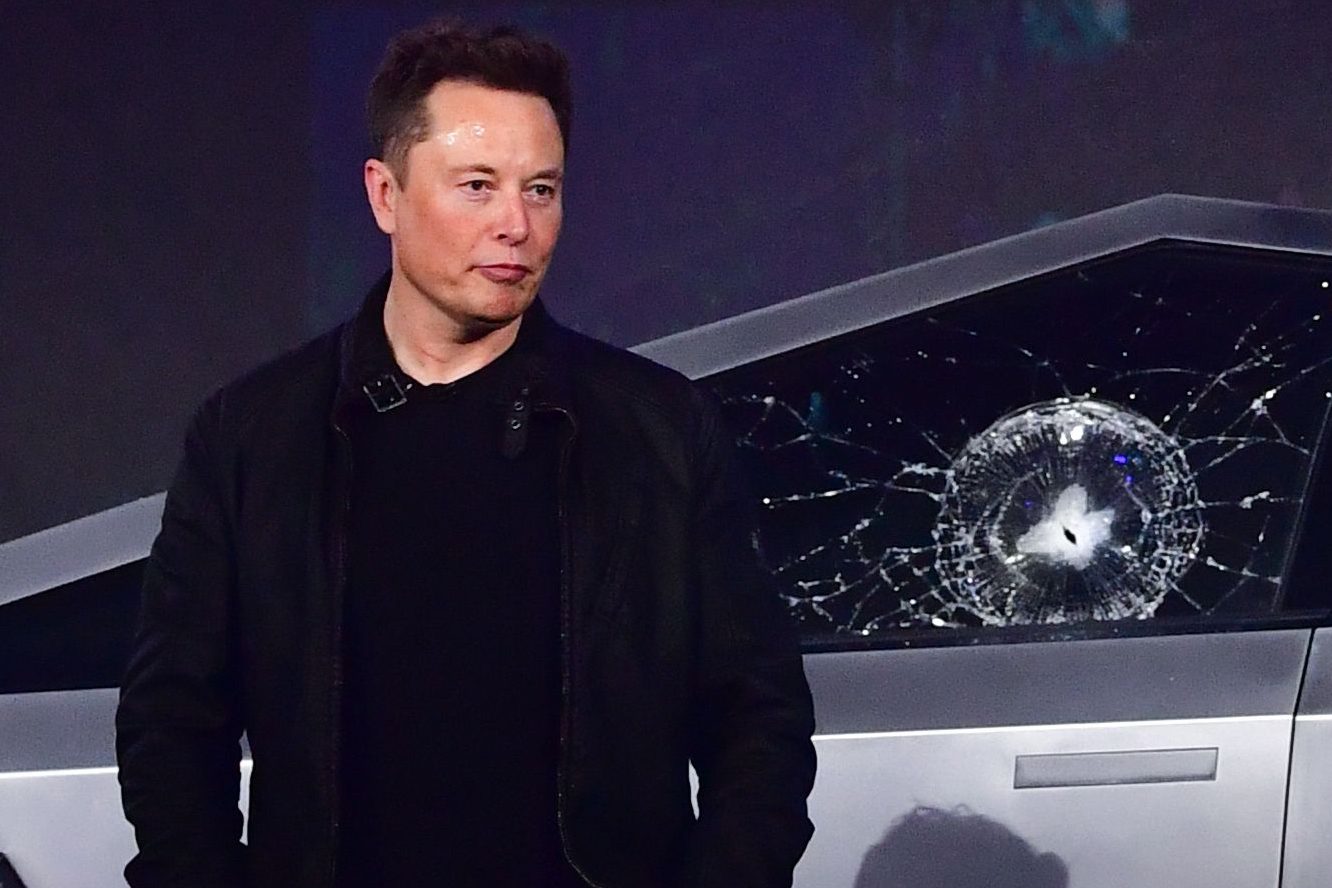 Tesla co-founder and CEO Elon Musk stands in front of the newly unveiled all-electric battery-powered Tesla's Cybertruck
