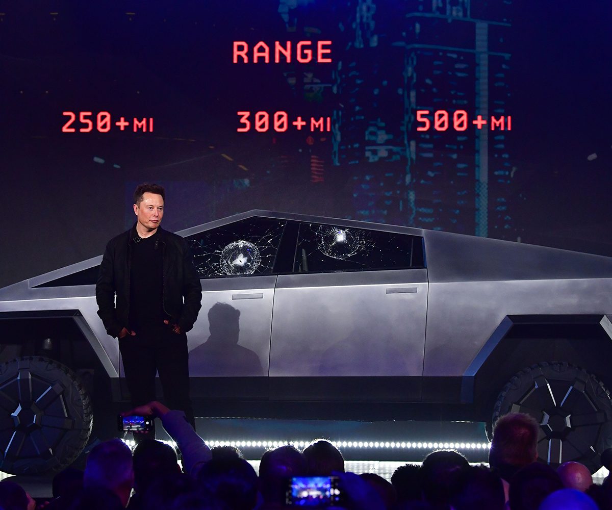Tesla co-founder and CEO Elon Musk stands in front of the newly unveiled all-electric battery-powered Tesla's Cybertruck