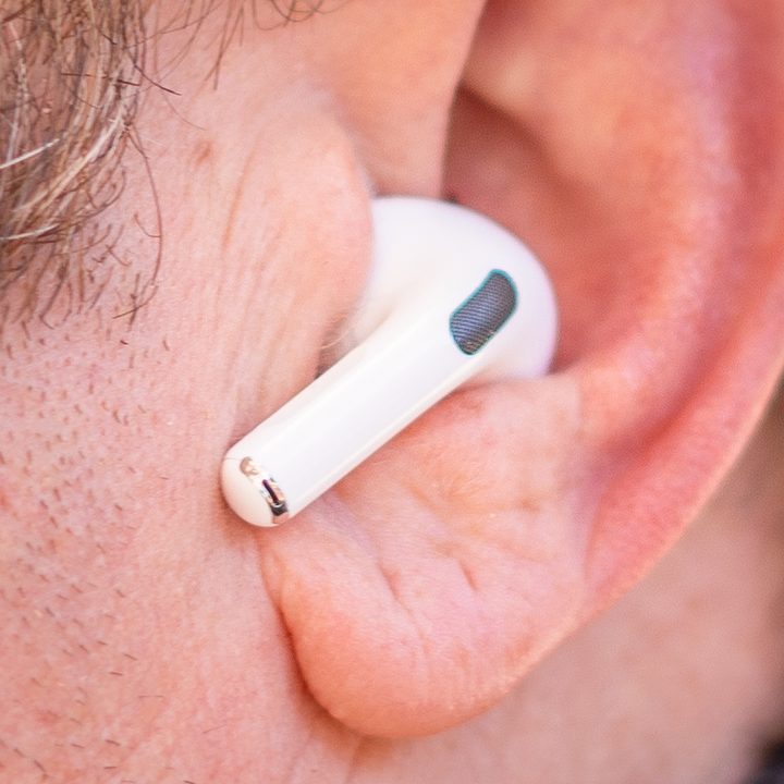 A close up of Apple AirPods Pro in an ear.