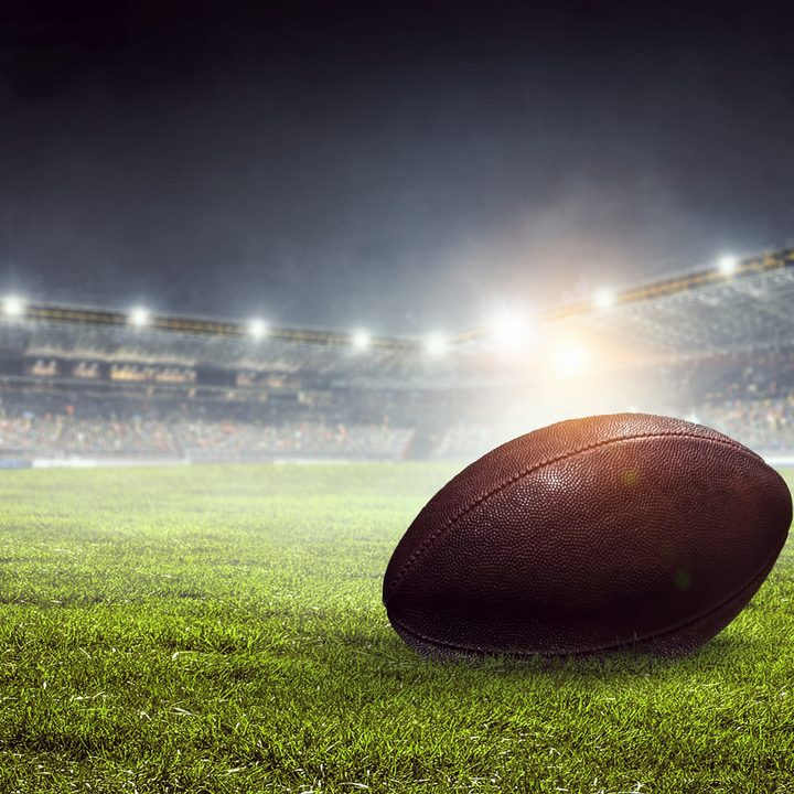 A football in a stadium on the field.