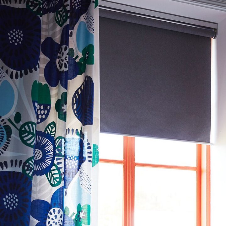 Ikea Frytur motorized window blinds in a room with curtains nearby.