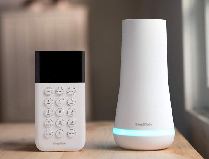 The SimpliSafe keypad and base sitting on a table.