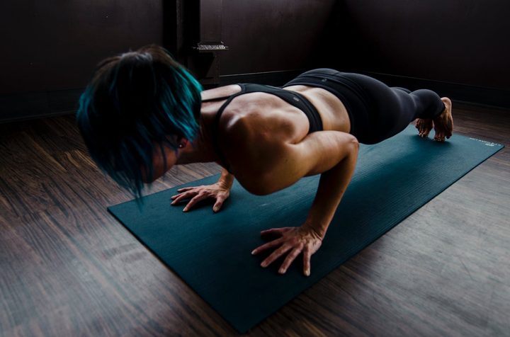 Woman doing yoga move on mat