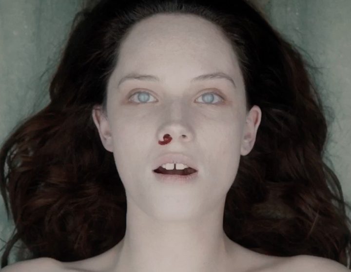 A dead woman on a slab with blood coming from her nose in The Autopsy of Jane Doe.