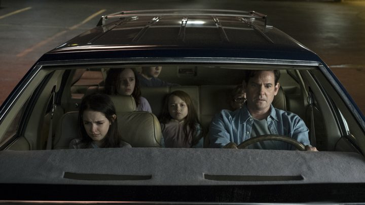 The cast of The Haunting of Hill House pictured in a car.