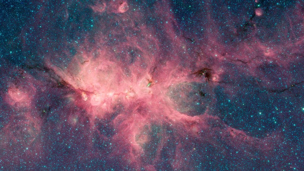 The Cat's Paw Nebula, imaged here by NASA's Spitzer Space Telescope using the IRAC instrument, is a star-forming region inside the Milky Way Galaxy. The dark filament running through the middle of the nebula is a particularly dense region of gas and dust.