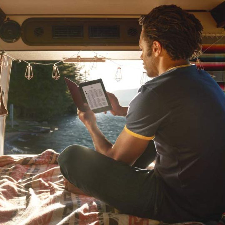 Reading a Kindle Paperwhite in van