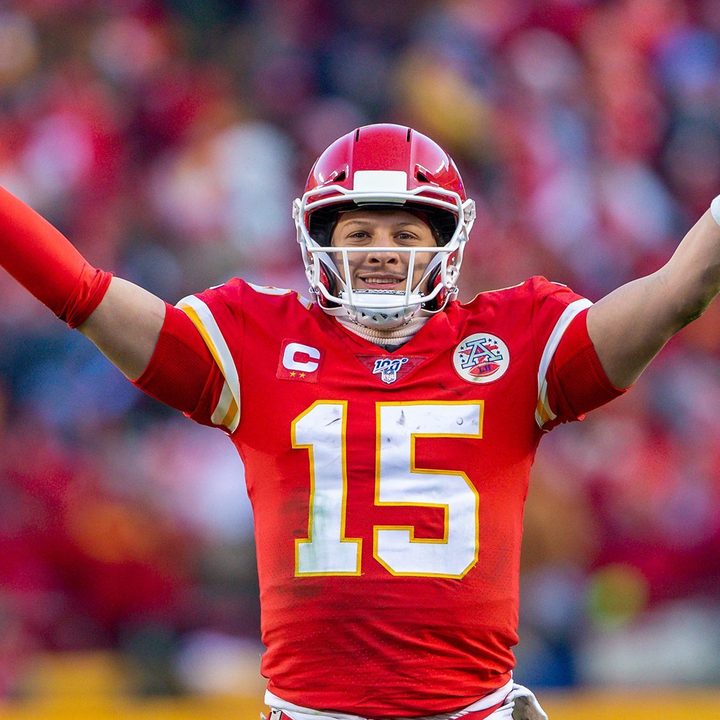 Patrick Mahomes holds his arms up.