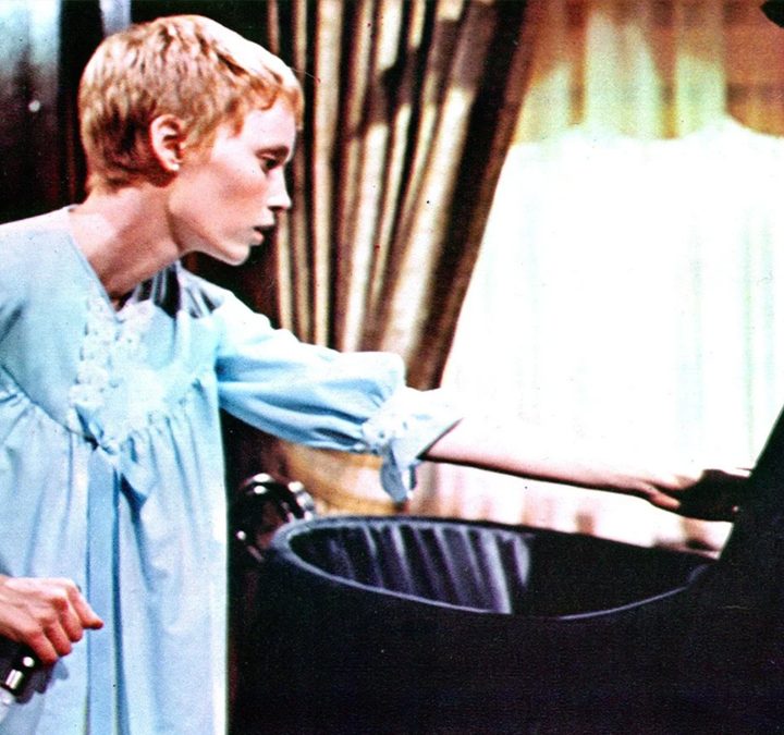 Rosemary looking into a crib in "Rosemary's Baby."
