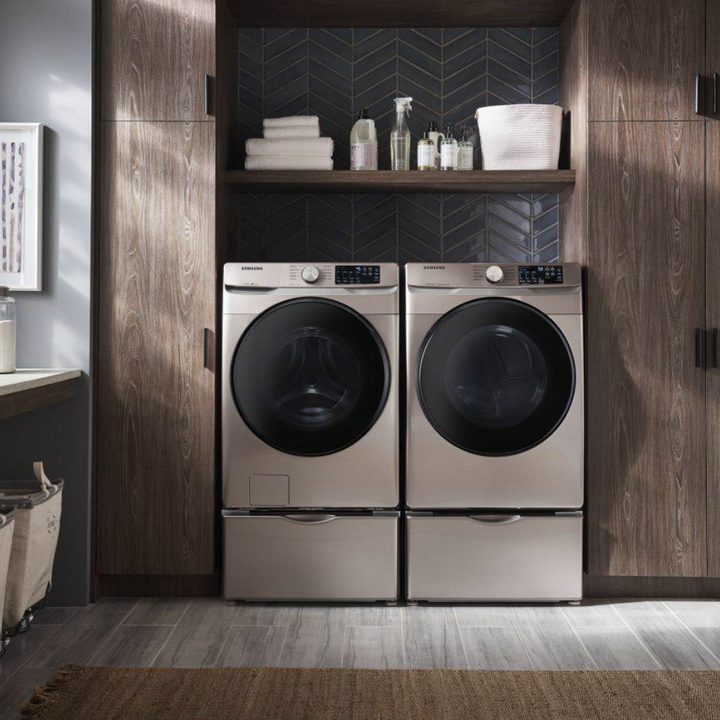 A washer and dryer sit next to each other in a laundry room.