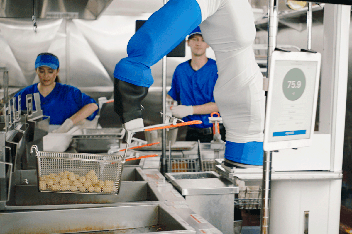 Flippy removing chicken tenders from the frier
