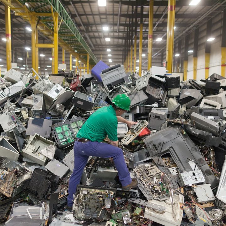 A man standing in e-waste.