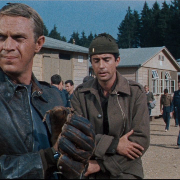Two prisoners stand in the yard of a camp in The Great Escape.