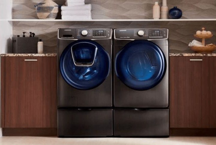 A washer and dryer sit next to each other in a laundry room.