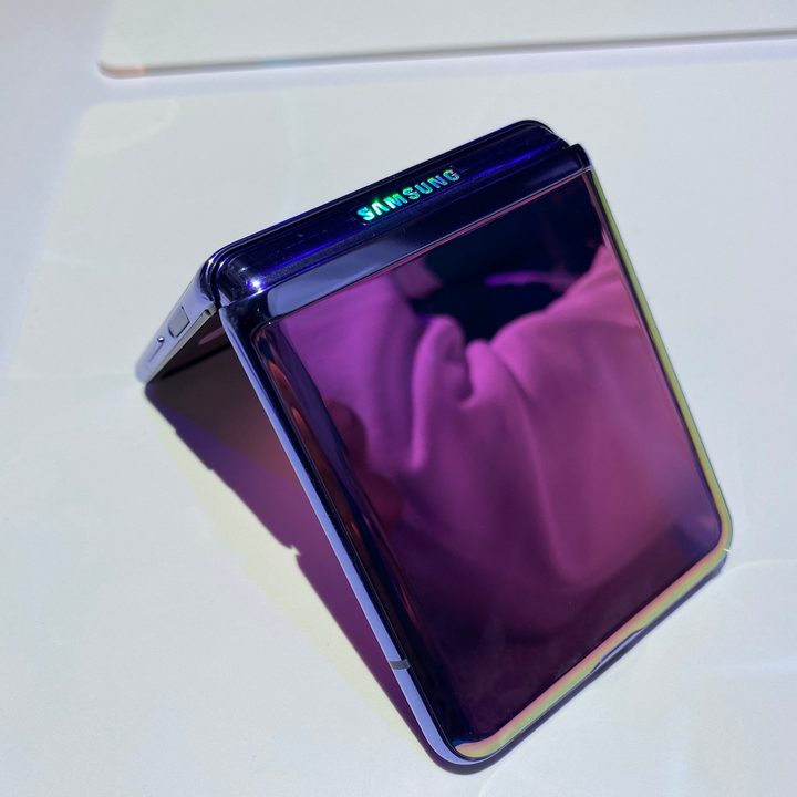 The Galaxy Z Flip face down on a table, half folded.