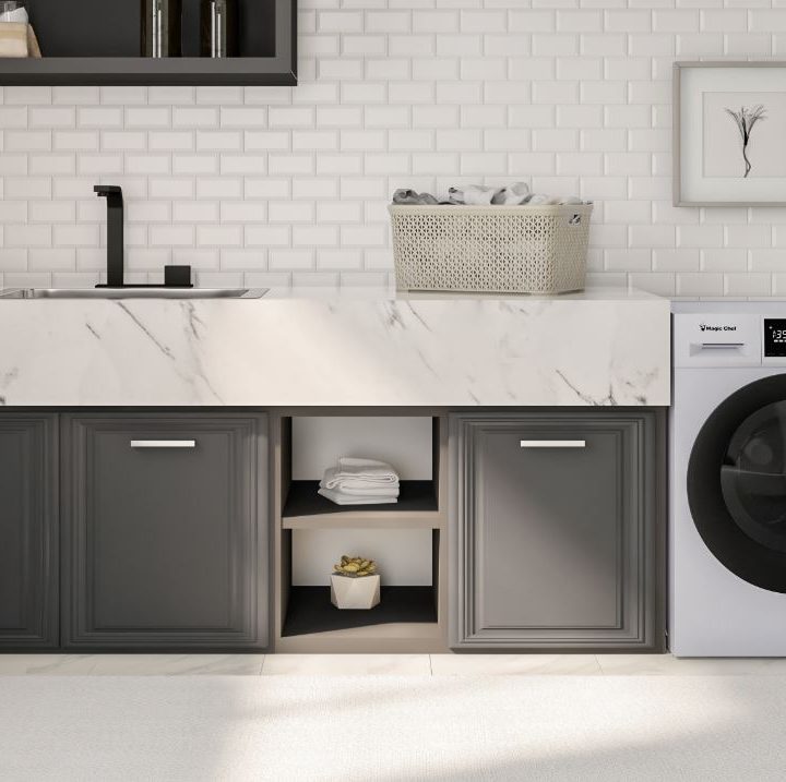 A washing machine sits in a laundry room.