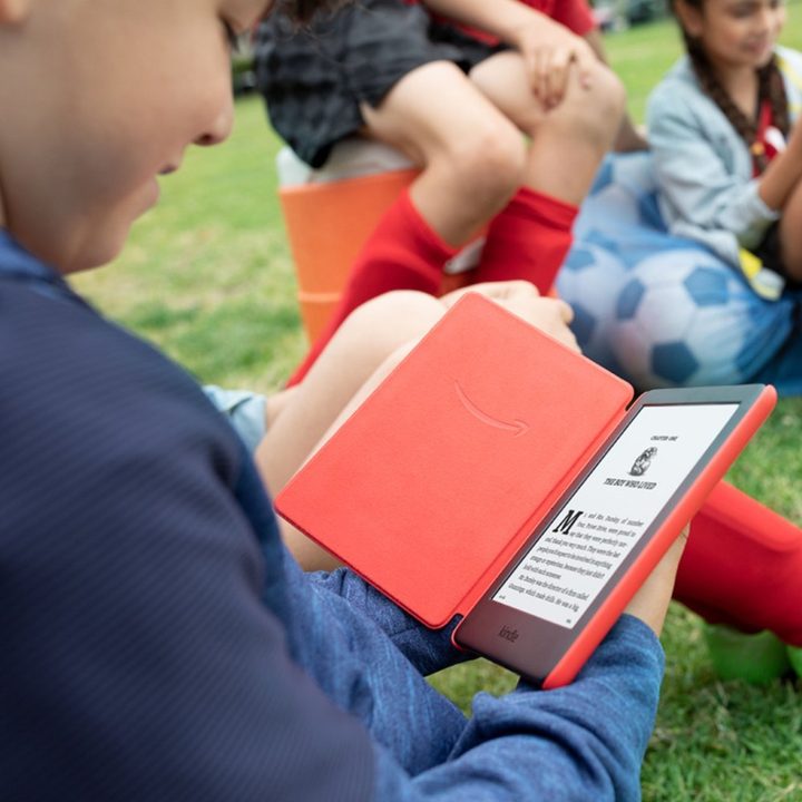 Child reading Amazon Kindle Kids Edition.