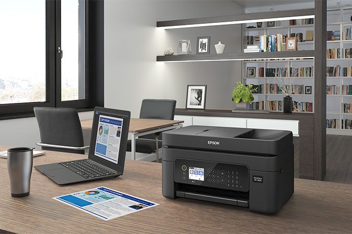 Epson printer sitting on a desk in an office.